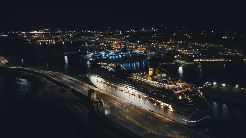 a large cruise ship in the middle of the water at night