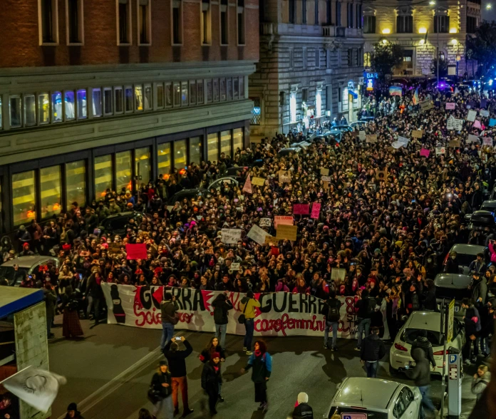 a large crowd of people in the street on their sides