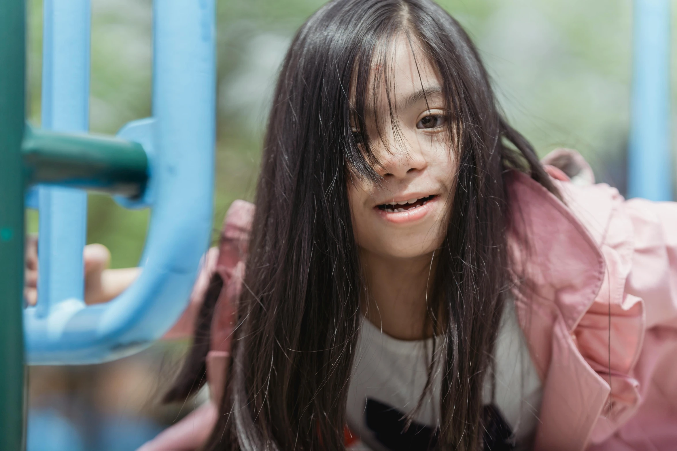 a child playing on a playground equipment in a park