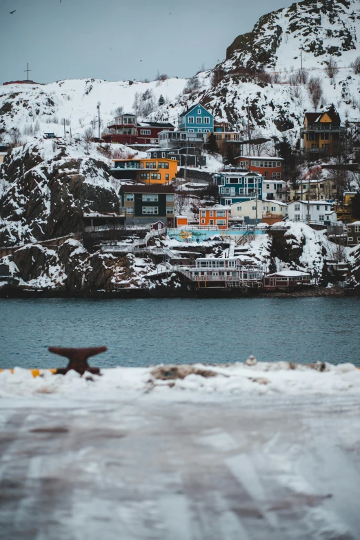 a snowy landscape with a star and houses along the lake