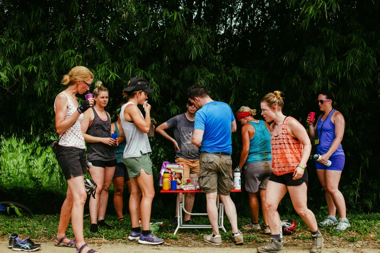 a group of people standing around talking on cellphones