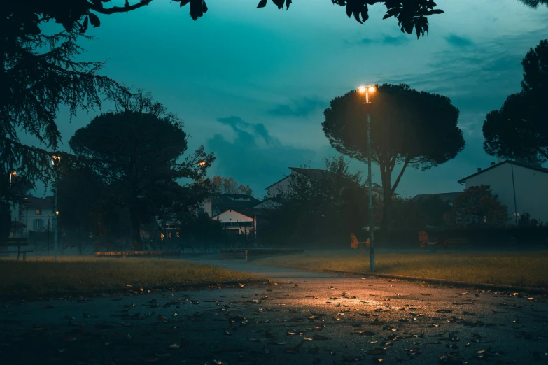 a dirt road at night with the lights on