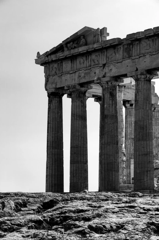 some very big old ancient pillars in the grass