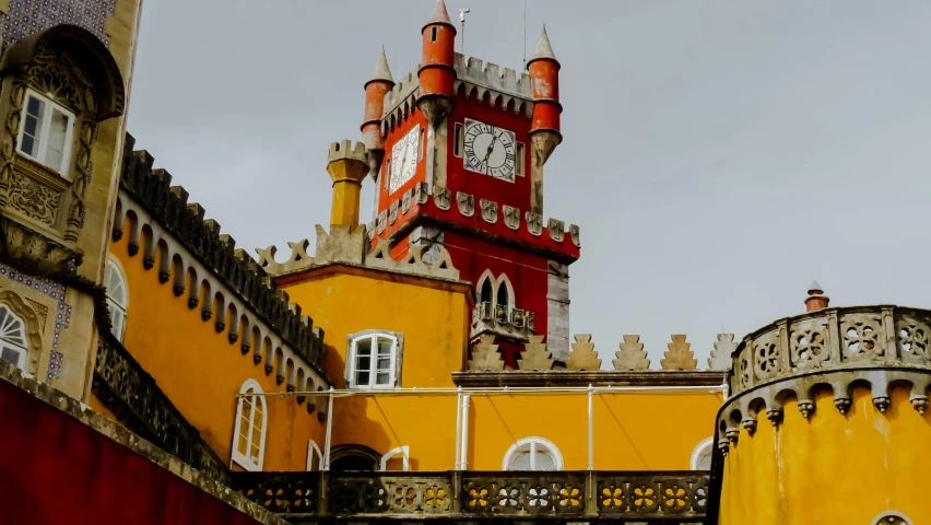 a large yellow and red tower on a building