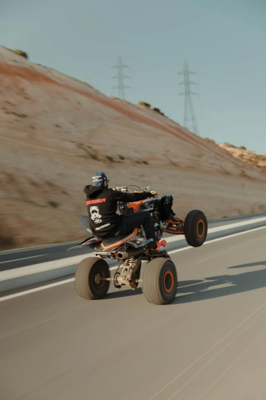 a motorcyclist riding down the road during the day