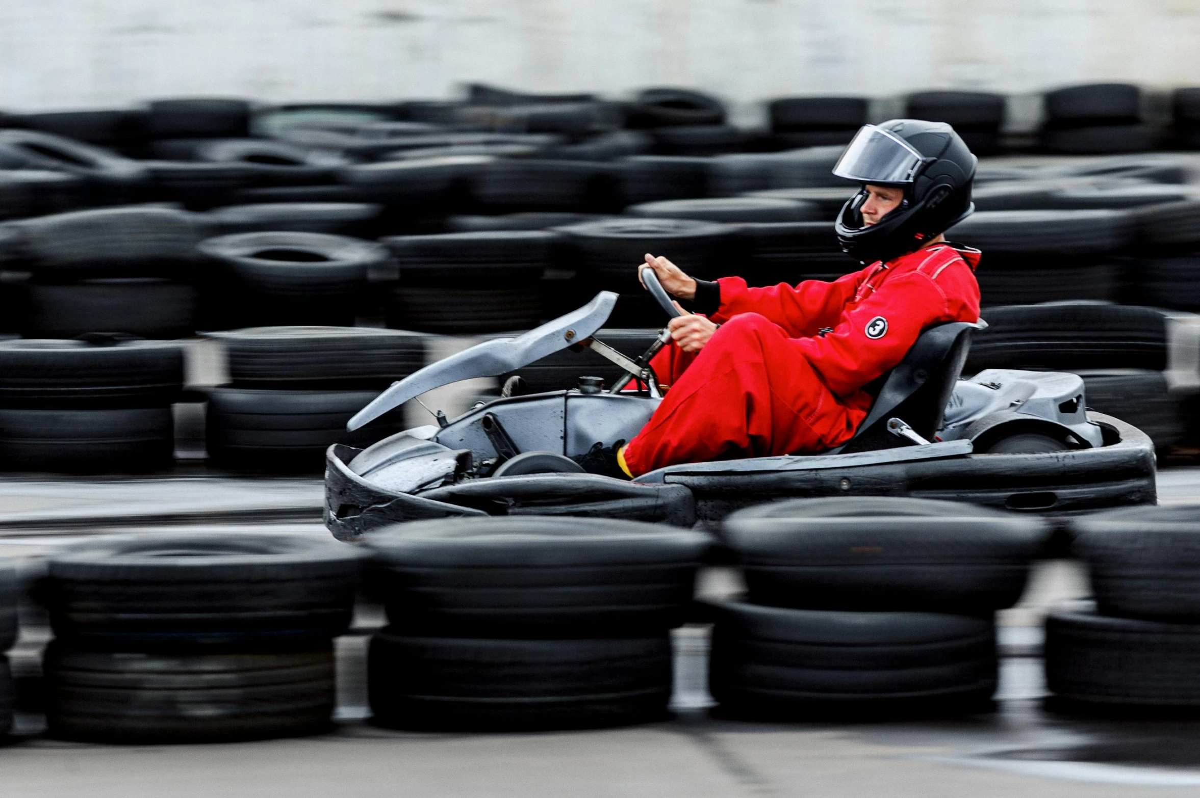 a person in red sitting on an open race car