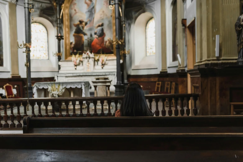 a woman is in an old church with the pews turned to the side