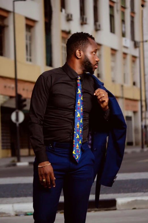 a man in a suit and tie standing on the side of the road