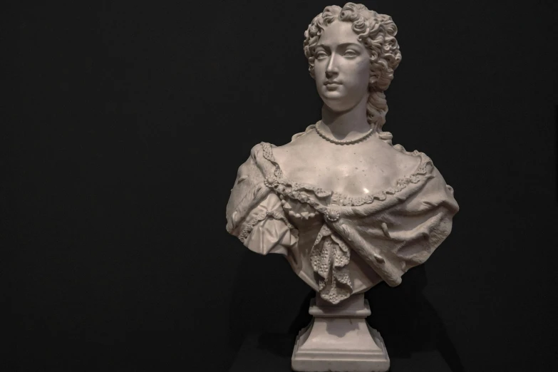a white statue with a curly hair