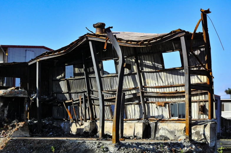 the remains of an old wooden building that is being repaired