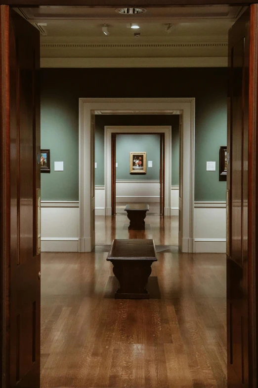 two benches are in the hallway of an historic building