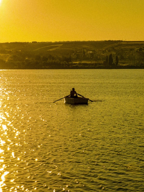 a person sitting in a boat on the water