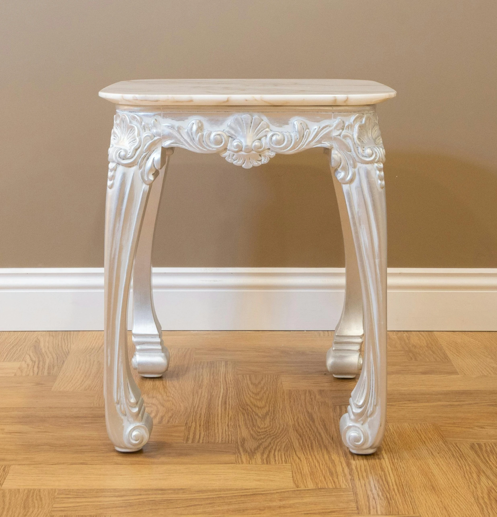 there is a white console table on the hardwood floor