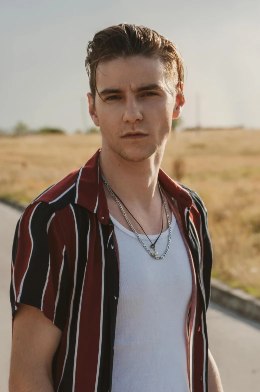 a guy with a white t - shirt and a red striped jacket