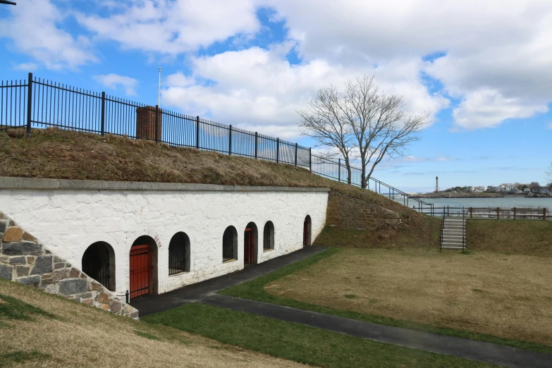 an old building with a green roof and fence