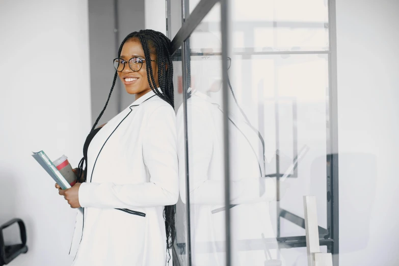 there is a woman in a business suit holding a binder and books