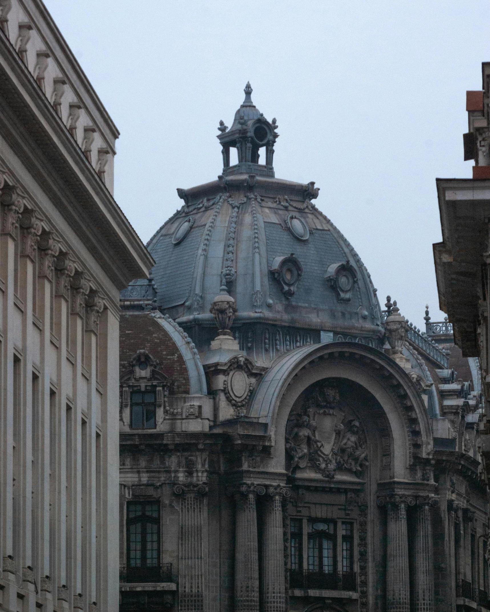 a building with an elaborate dome on top next to several buildings