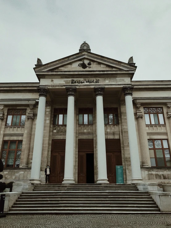 old building with stone stairs leading to the second floor