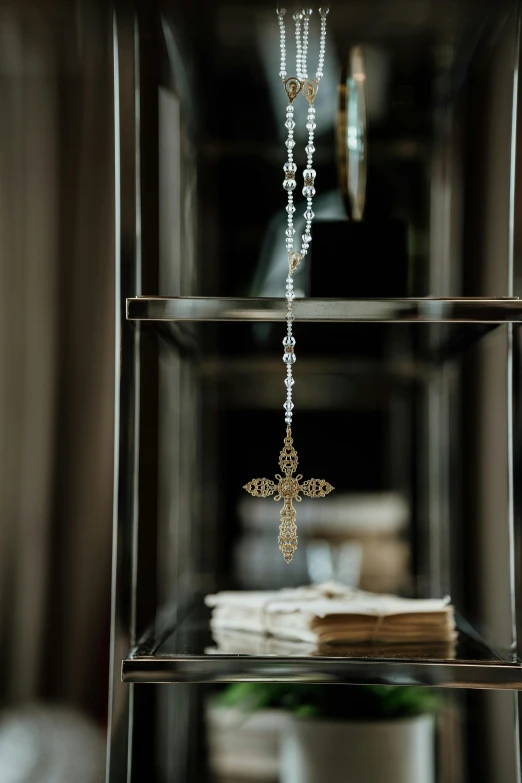 a hanging cross on a shelf in a home