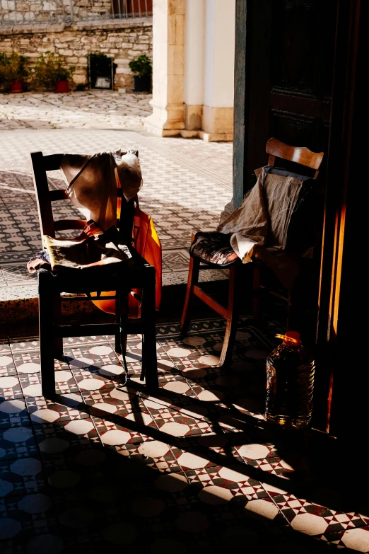 a chair is in the shadow of an open door