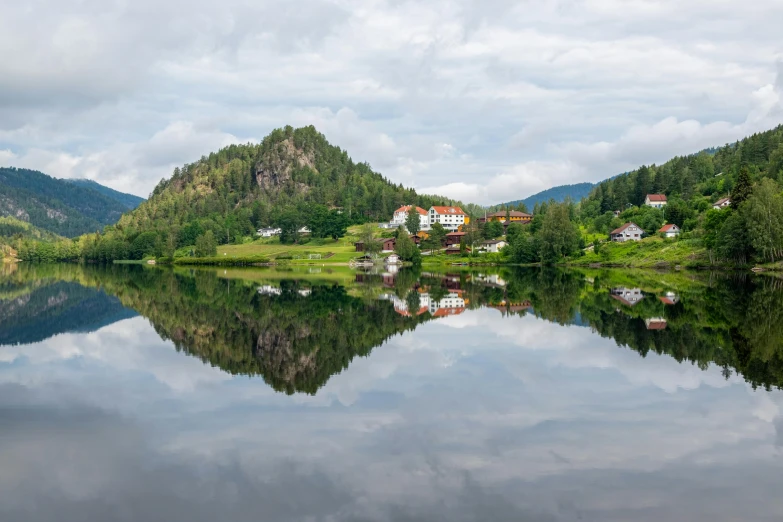 a view of mountains and lake on cloudy day