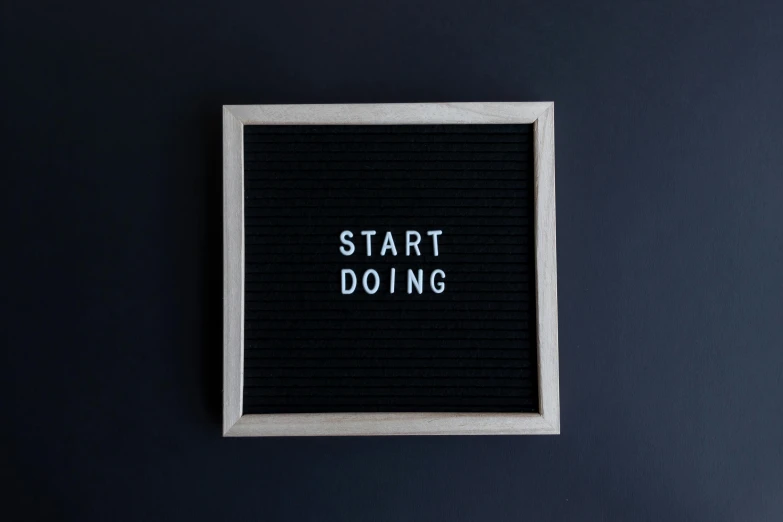 a word on a picture frame stating start doing