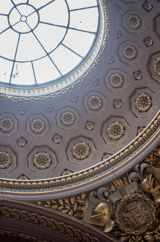 the ceiling in an ornate building with a round window