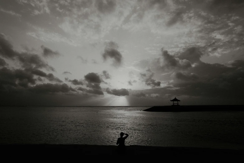 two people are standing in the water on the shore