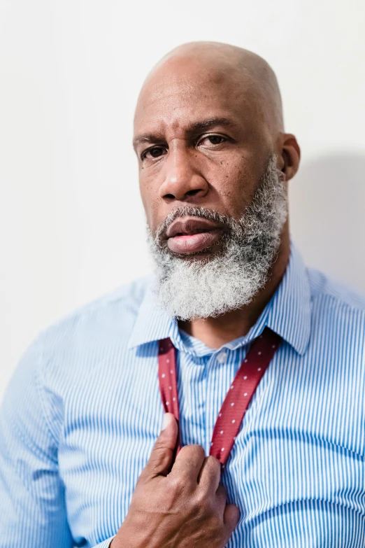 an african american man with beard and tie