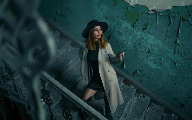 young woman walking up a stair case holding onto her cell phone