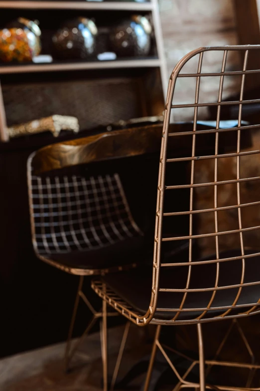 two metal chairs in front of a bookcase