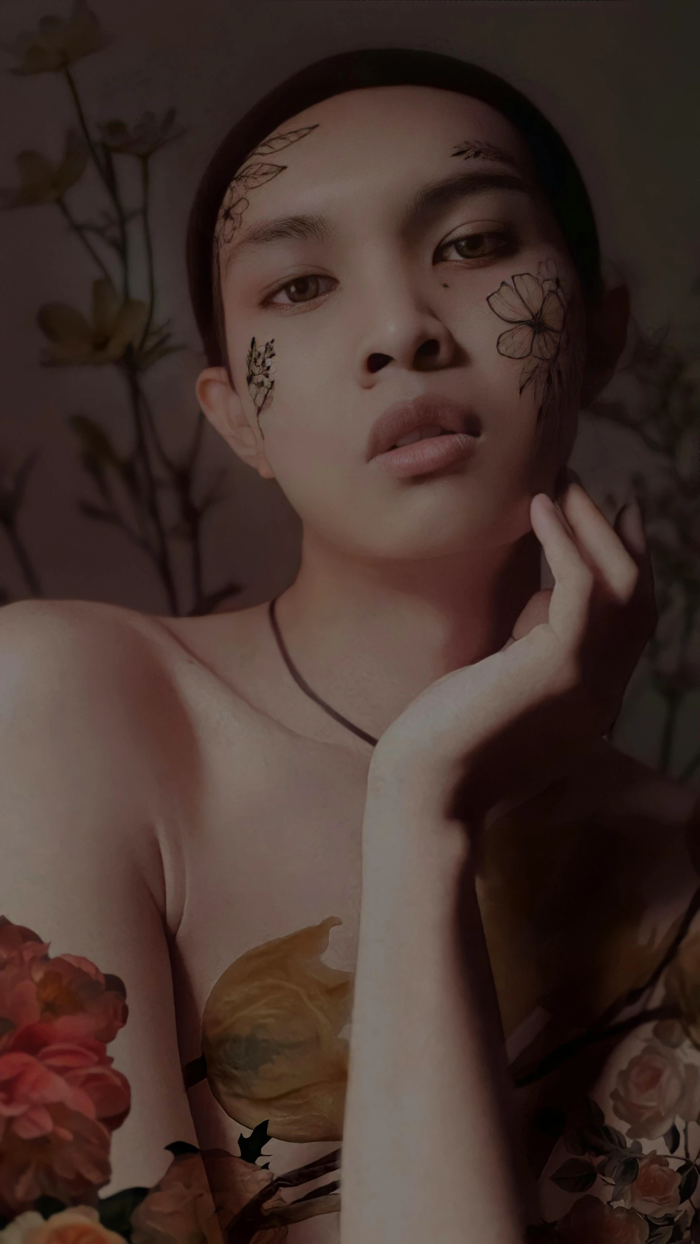 a woman with face paint poses in front of flowers