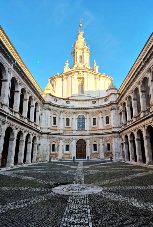 a large building has stone floors and columns in it