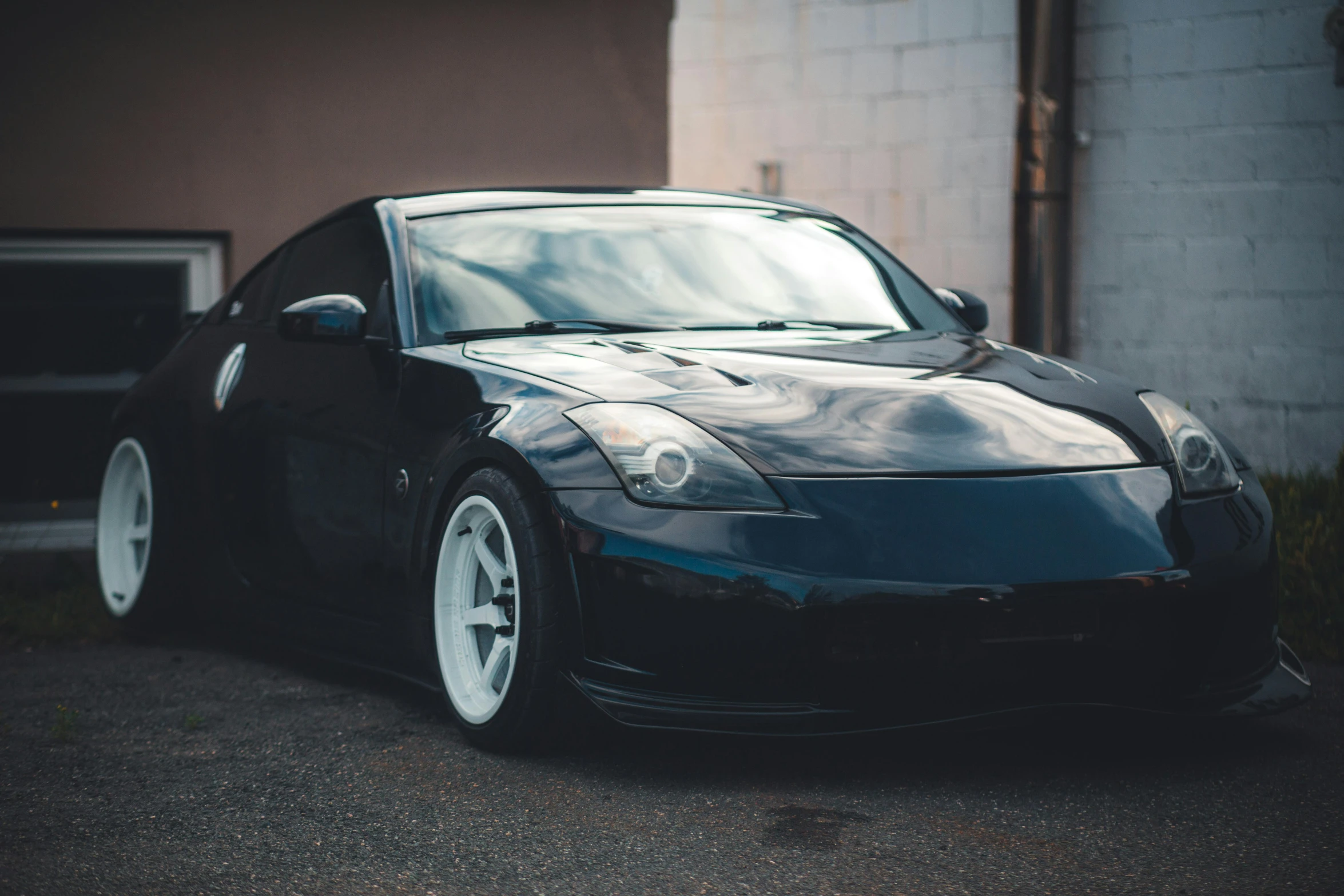 a car parked outside the garage with a door open