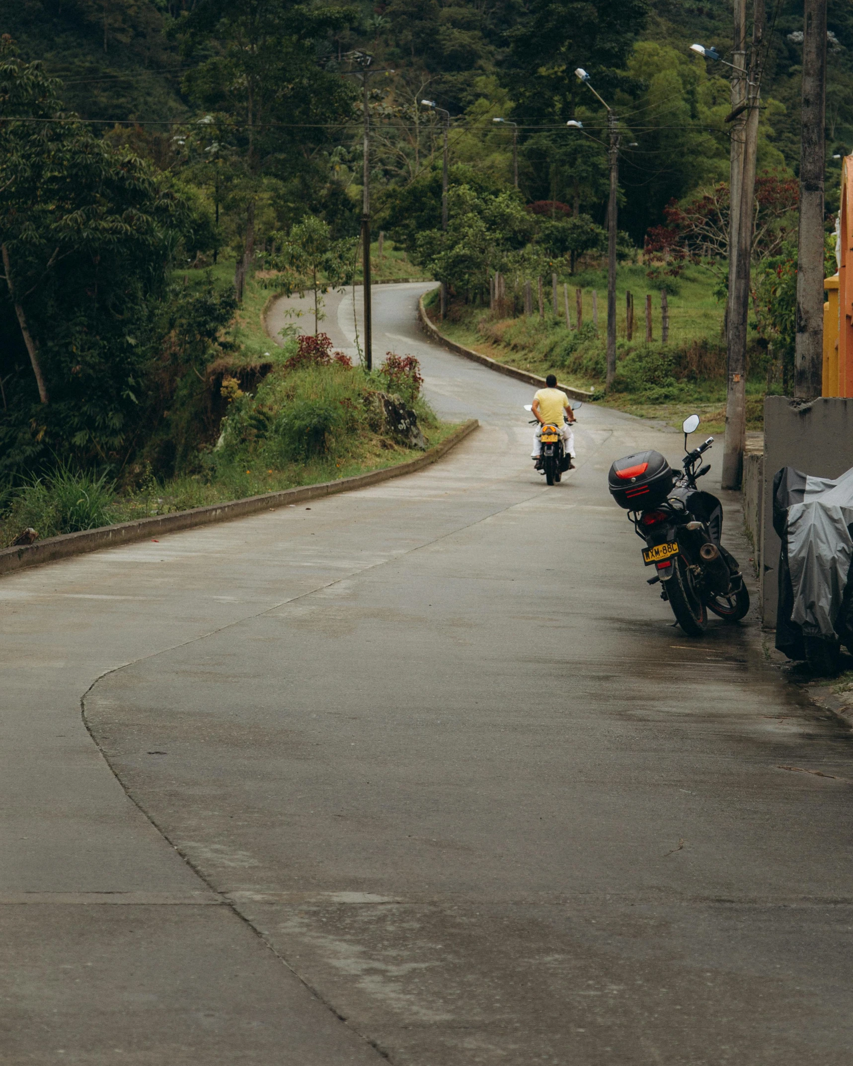 a motorcycle parked on the side of a road next to trees