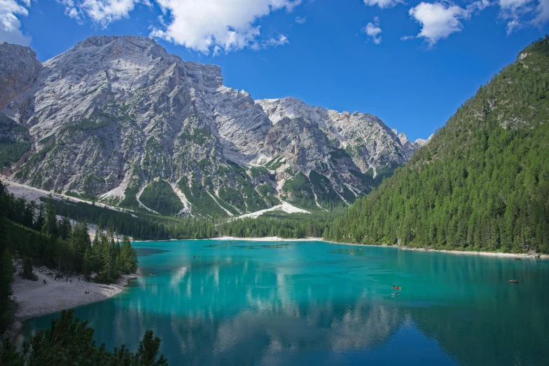 the mountain view shows bright blue water, green and clear