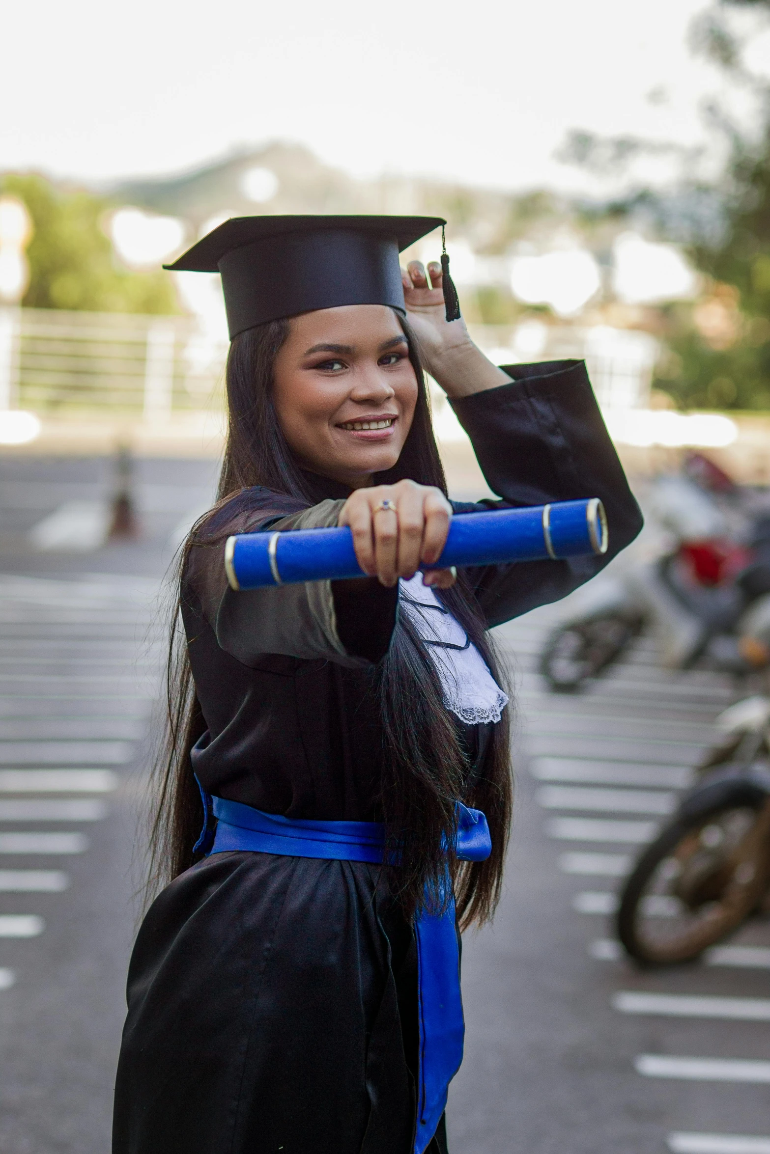 a girl with graduation hat and long black wig