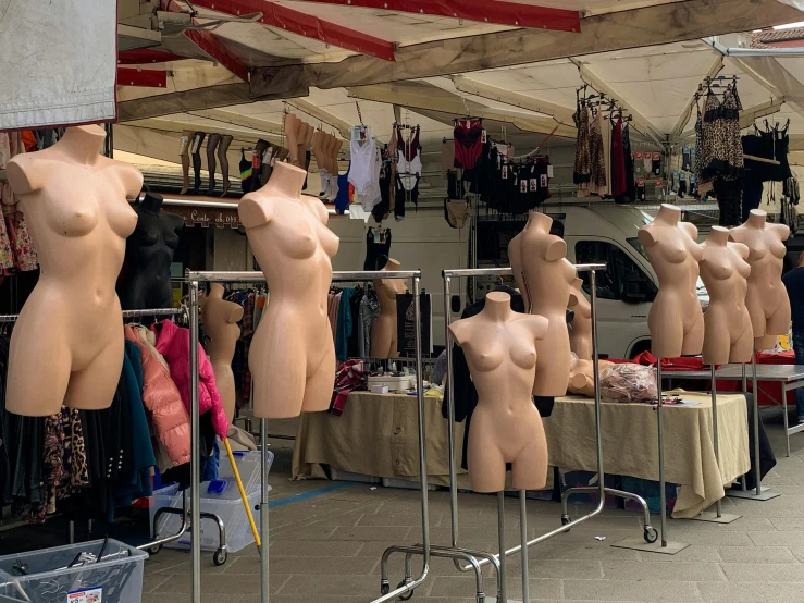 many  ladies are shown on the streets under a canopy