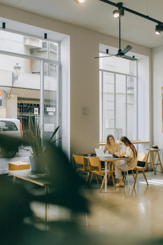 people sitting at small tables in a room