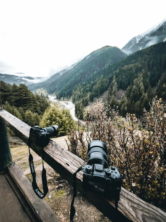 an empty camera bag and two pairs of shoes on the ledge above