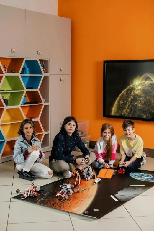 a group of people playing with legos in a room