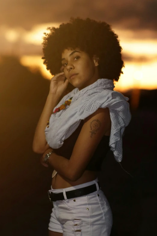 woman with tattoo posing for po wearing white shorts