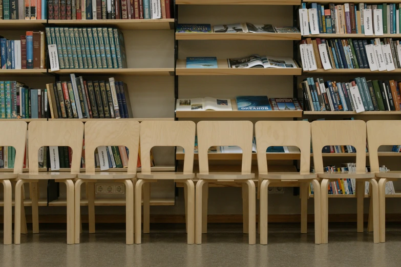 a line of chairs with books and magazines in a liry