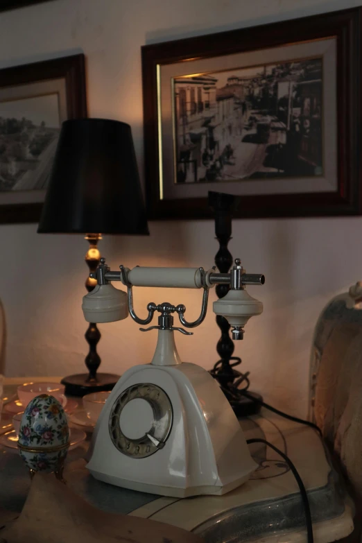 an old - fashioned telephone on a coffee table with three lamp shades