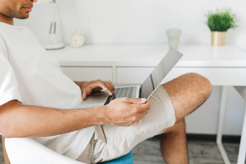 man working on laptop computer at home office area