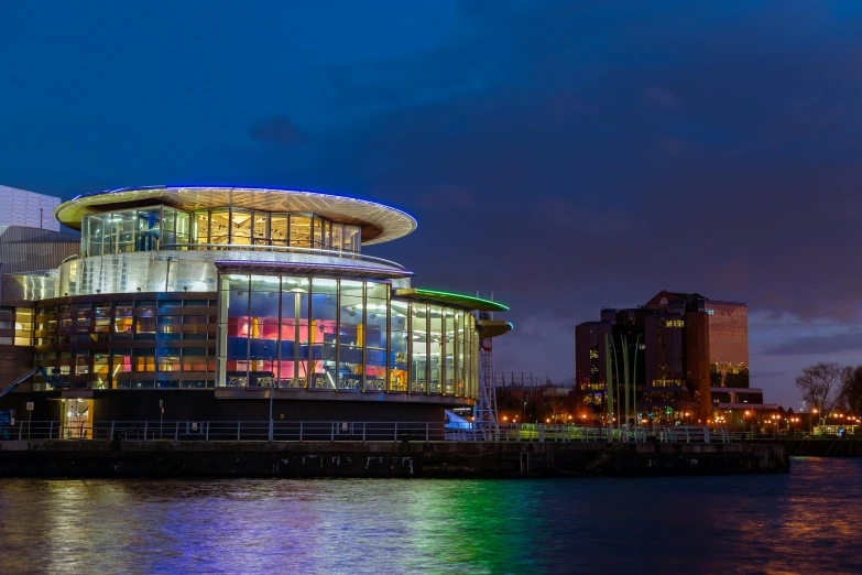 a modern building at night by the sea