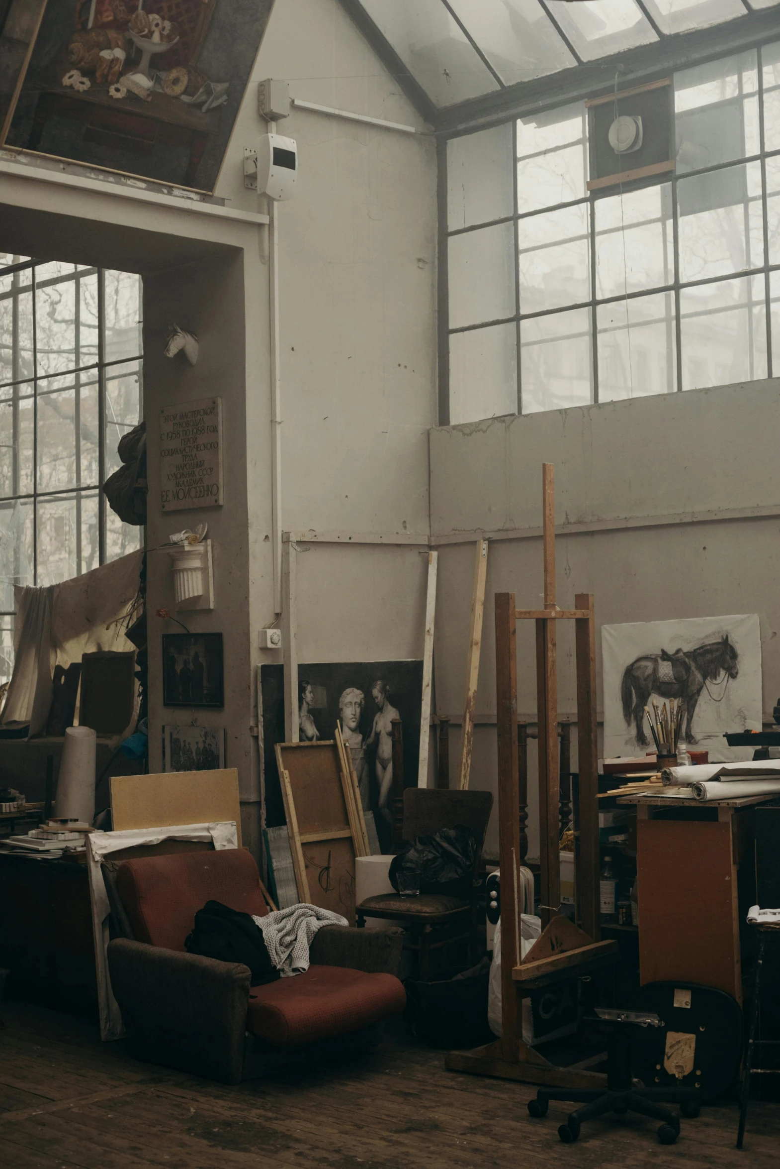 the room with large windows and several chairs