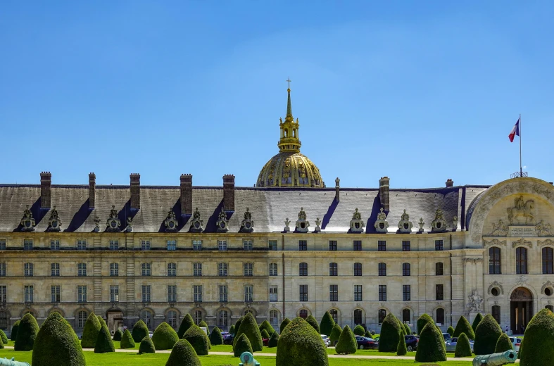 a large building with a dome on top is in a park