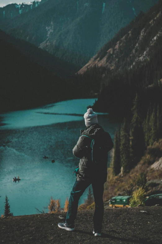 a person standing on a cliff overlooking water