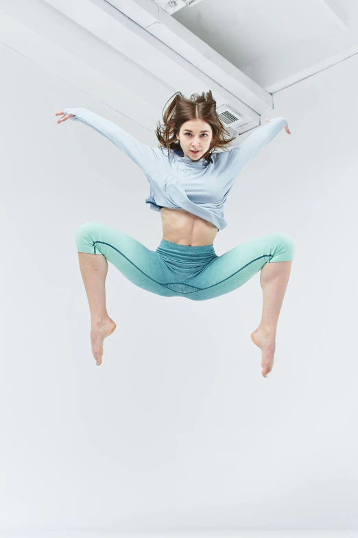 a woman in midair and dancing clothes